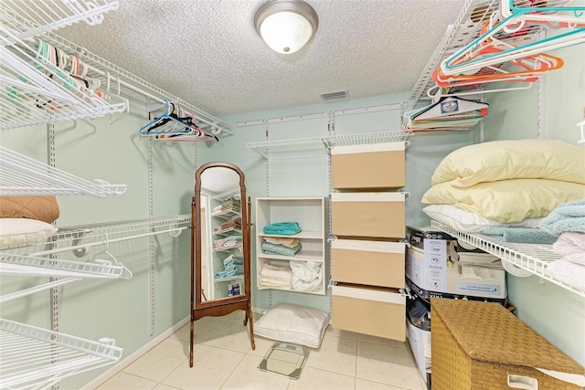 spacious closet featuring light tile floors