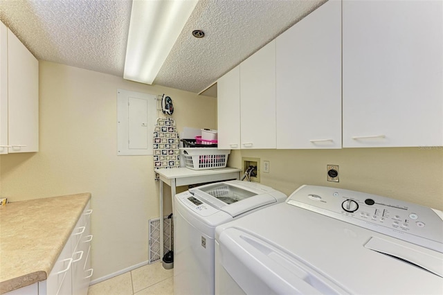 washroom featuring cabinets, a textured ceiling, independent washer and dryer, washer hookup, and light tile floors