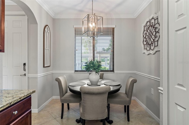 tiled dining room with a notable chandelier and crown molding