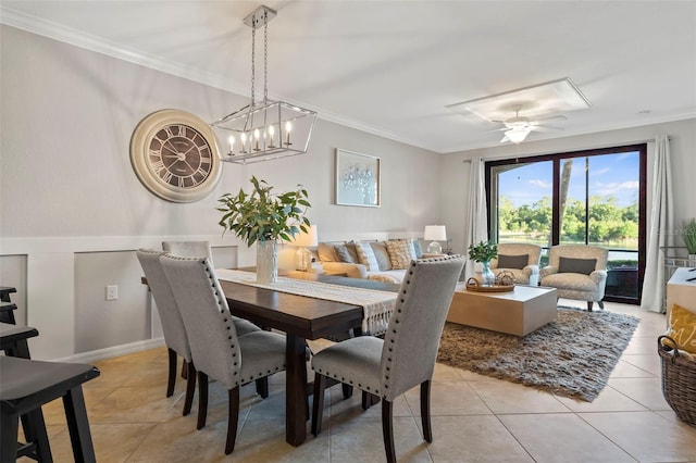 dining space with light tile flooring, ceiling fan with notable chandelier, and crown molding