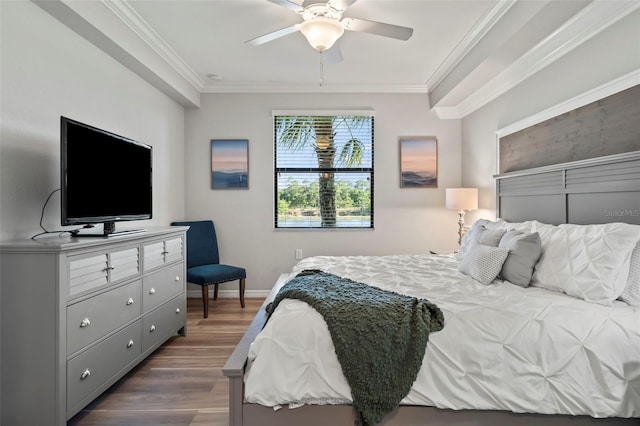 bedroom featuring crown molding, dark hardwood / wood-style flooring, and ceiling fan