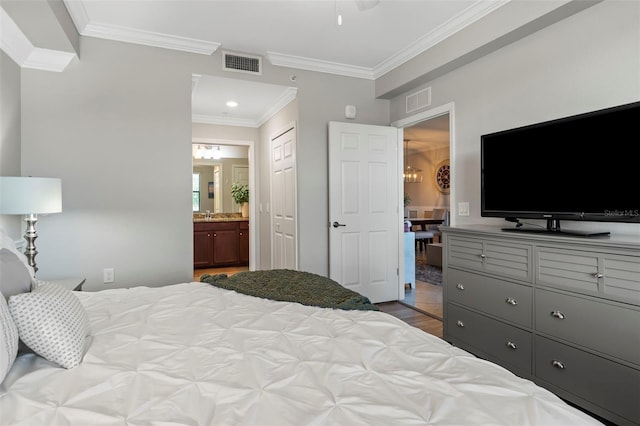 tiled bedroom with a closet, sink, ensuite bathroom, and ornamental molding