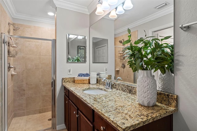 bathroom featuring ornamental molding, oversized vanity, and an enclosed shower