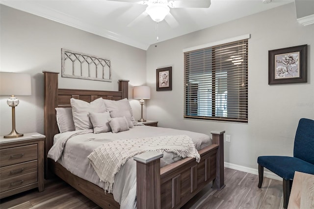 bedroom with ceiling fan, crown molding, and dark hardwood / wood-style floors