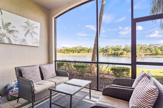 sunroom / solarium with a water view