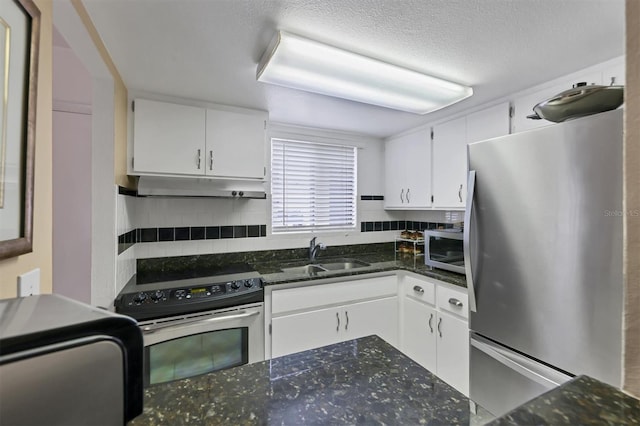 kitchen featuring sink, appliances with stainless steel finishes, dark stone countertops, and white cabinetry