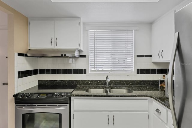 kitchen with a wealth of natural light, appliances with stainless steel finishes, white cabinetry, and sink