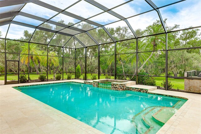 view of swimming pool with glass enclosure and an in ground hot tub