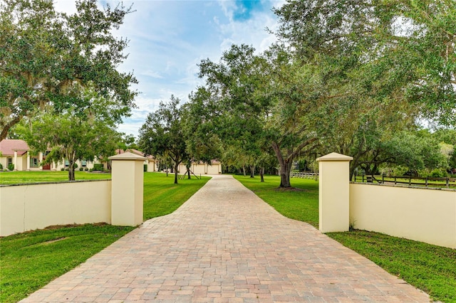 surrounding community featuring a fenced front yard and a lawn