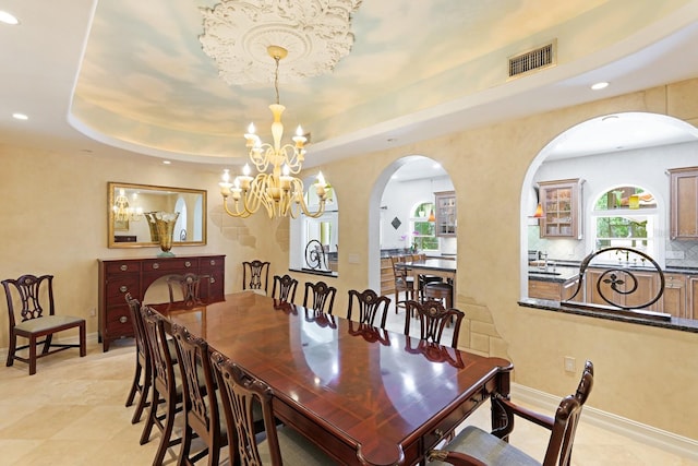 dining area with recessed lighting, visible vents, baseboards, a tray ceiling, and an inviting chandelier