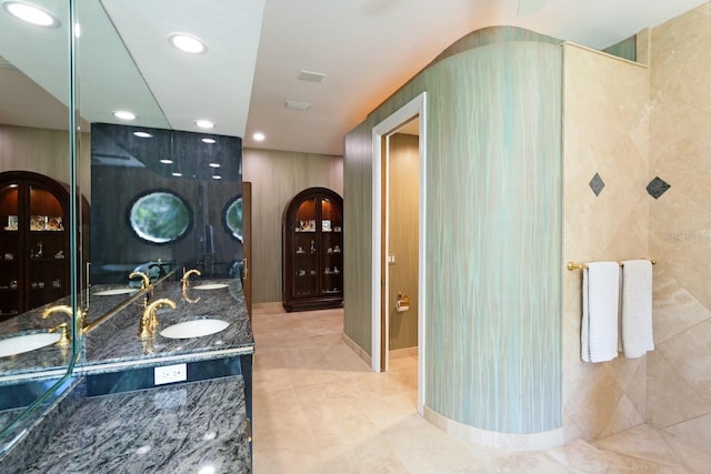 full bathroom with recessed lighting, a sink, and double vanity