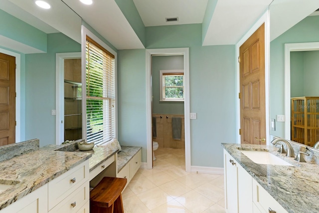 full bath with toilet, vanity, baseboards, visible vents, and tile patterned floors