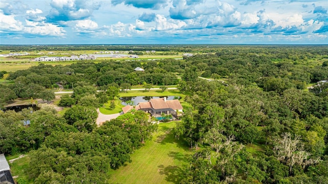 birds eye view of property with a forest view