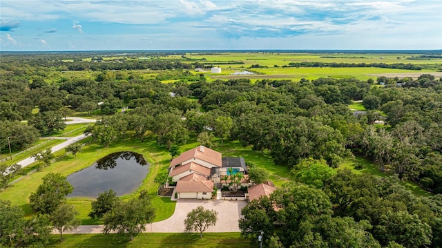 birds eye view of property with a water view and a wooded view