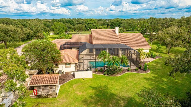 birds eye view of property with a wooded view