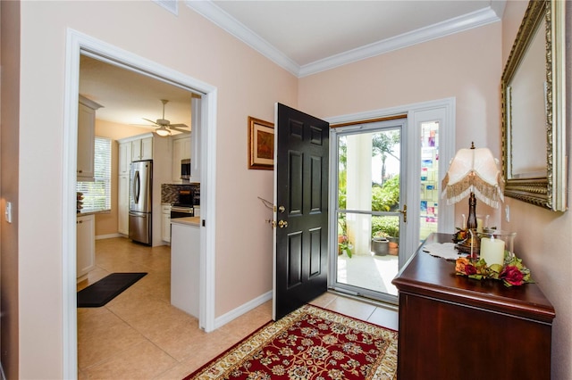 entryway featuring ornamental molding, ceiling fan, and light tile floors