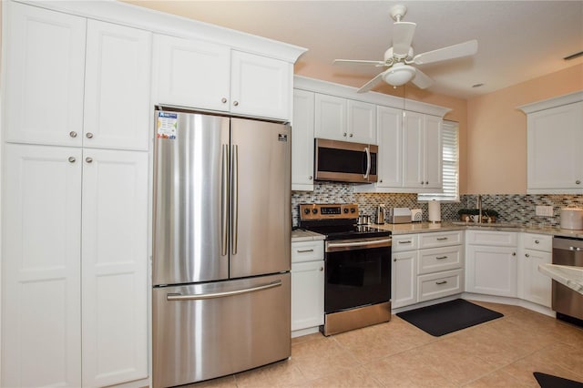 kitchen featuring backsplash, stainless steel appliances, and white cabinetry