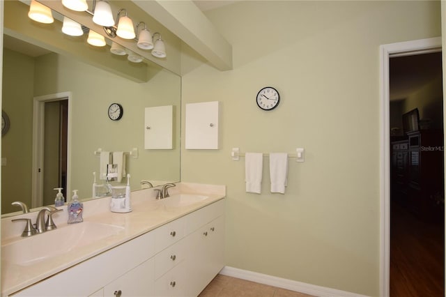 bathroom featuring dual sinks, oversized vanity, and tile flooring