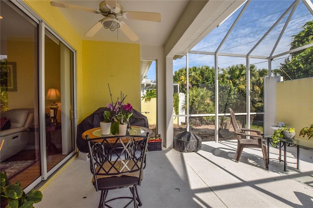 sunroom / solarium featuring ceiling fan