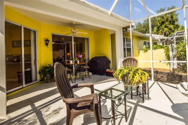 sunroom featuring ceiling fan