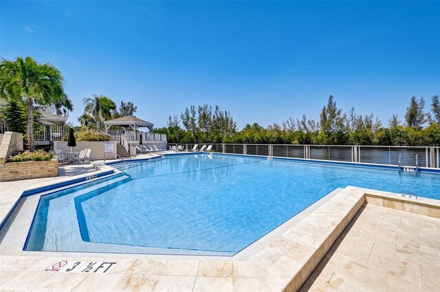 view of swimming pool with a gazebo and a patio area