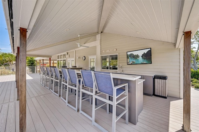 wooden terrace with an outdoor bar