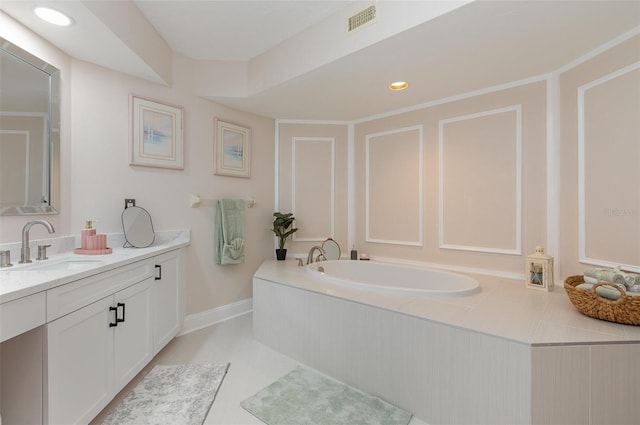 bathroom featuring tile patterned flooring, vanity, and a bathing tub