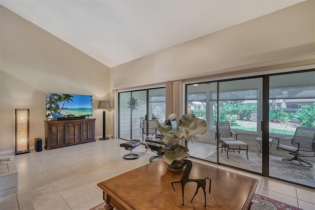 living room with high vaulted ceiling and light tile floors