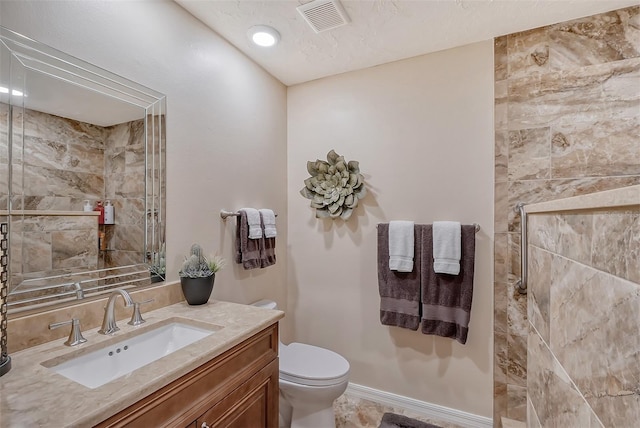 bathroom with toilet, tile floors, and vanity