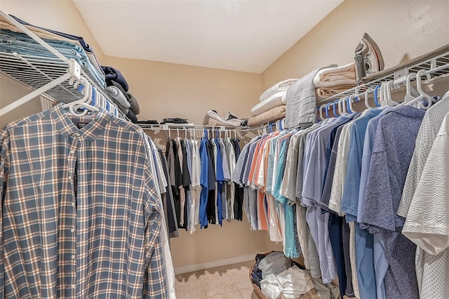 walk in closet featuring light tile flooring