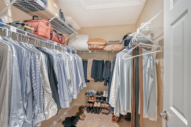 walk in closet featuring light tile floors