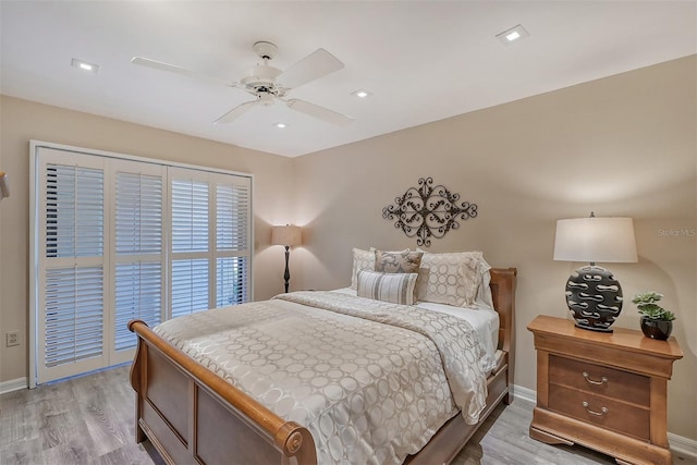 bedroom with light hardwood / wood-style floors, ceiling fan, and access to exterior