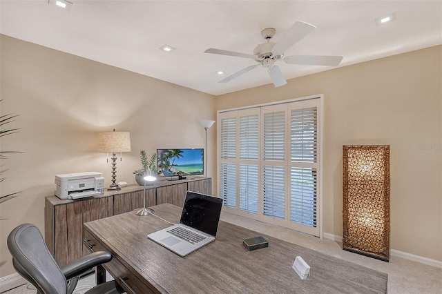 office with light carpet and ceiling fan