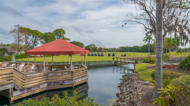 dock area featuring a lawn and a water view