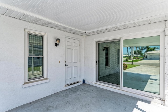 entrance to property featuring a patio