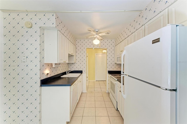 kitchen featuring white appliances, ceiling fan, white cabinetry, sink, and light tile floors