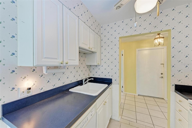 kitchen featuring ceiling fan, white cabinetry, sink, and light tile flooring