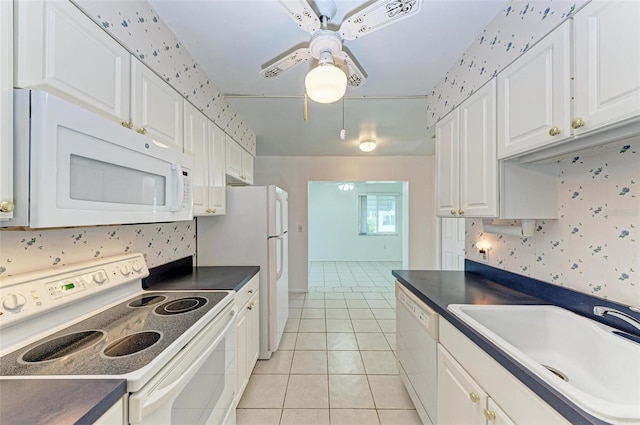 kitchen with ceiling fan, light tile floors, white cabinets, sink, and white appliances