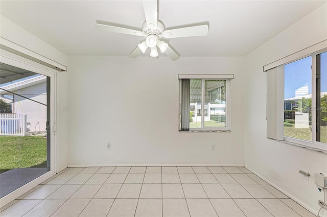 tiled spare room with ceiling fan