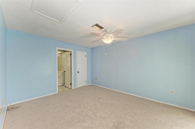 unfurnished room with light colored carpet, ceiling fan, and a textured ceiling