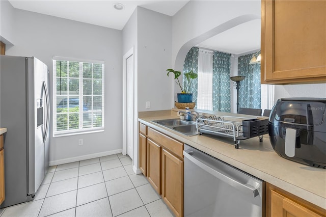 kitchen featuring sink, appliances with stainless steel finishes, and light tile flooring