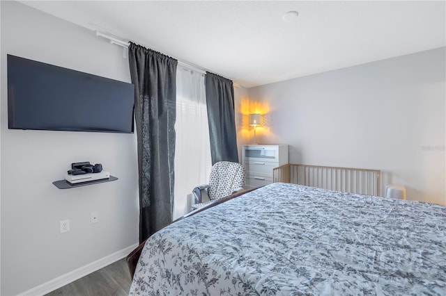 bedroom with hardwood / wood-style flooring