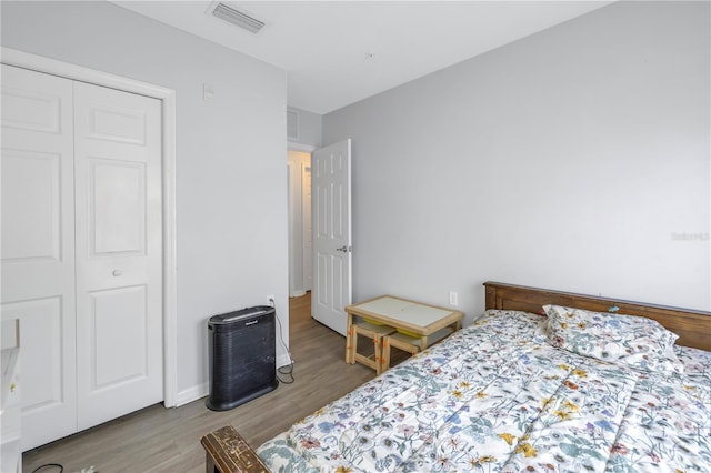 bedroom featuring hardwood / wood-style flooring and a closet