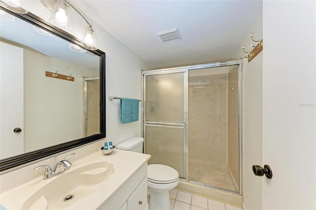 bathroom featuring a shower with shower door, toilet, tile flooring, and vanity