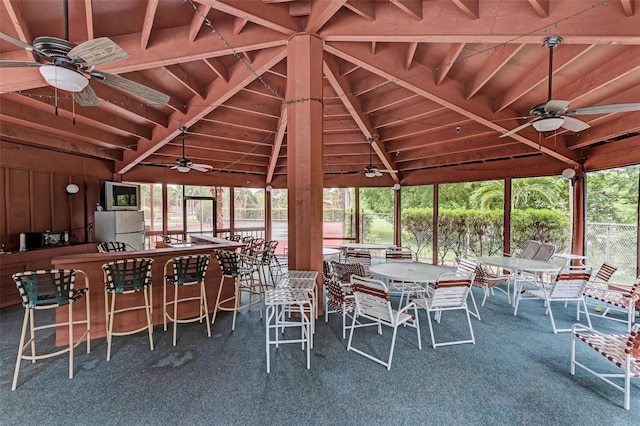 exterior space featuring ceiling fan and vaulted ceiling with beams