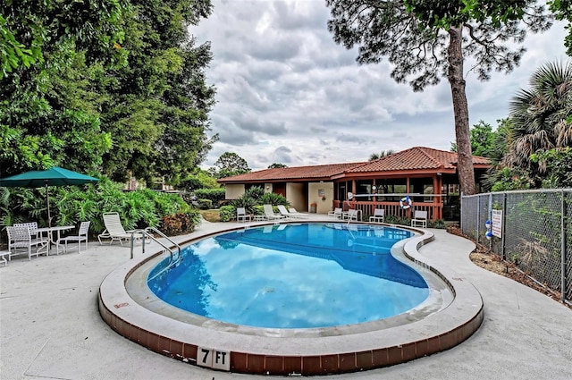 view of swimming pool featuring a patio area