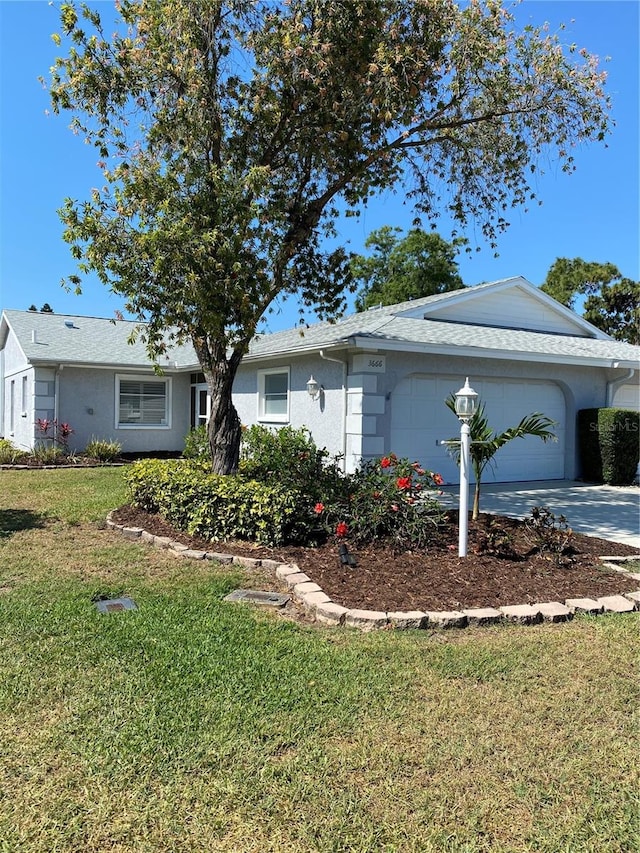 ranch-style home with a front lawn and a garage