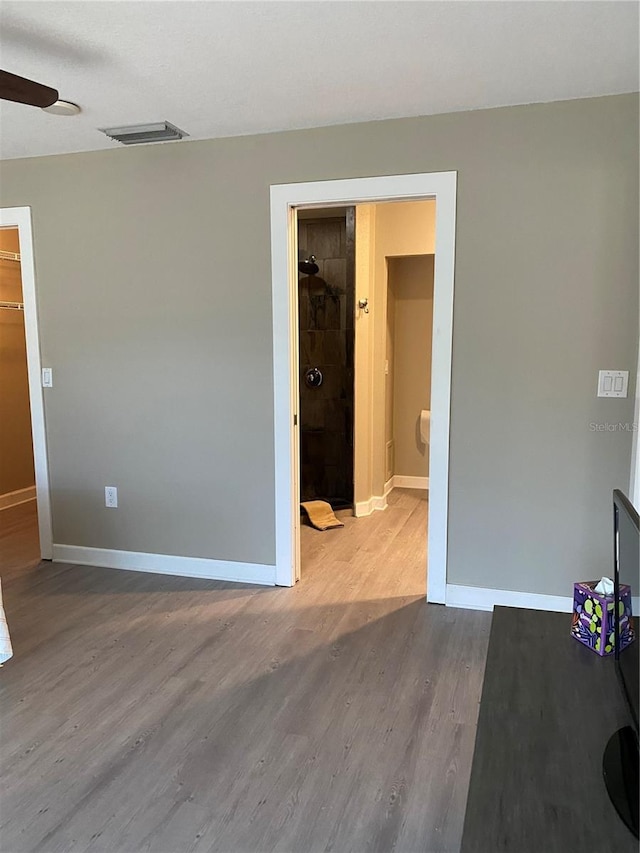 spare room with wood-type flooring and ceiling fan