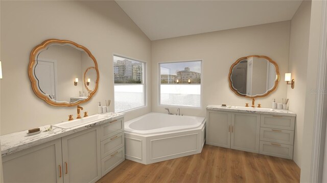 bathroom featuring lofted ceiling, a bath, hardwood / wood-style flooring, and vanity