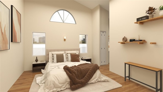 bedroom with high vaulted ceiling, light hardwood / wood-style floors, and multiple windows